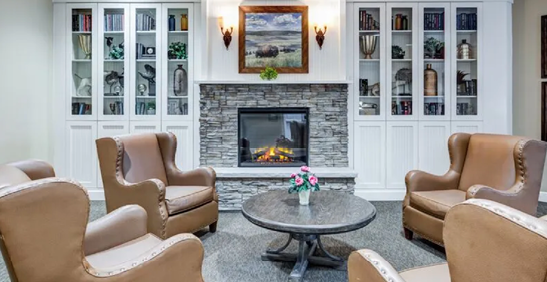 A living room with a fireplace and a table with a vase of flowers. AI generated content